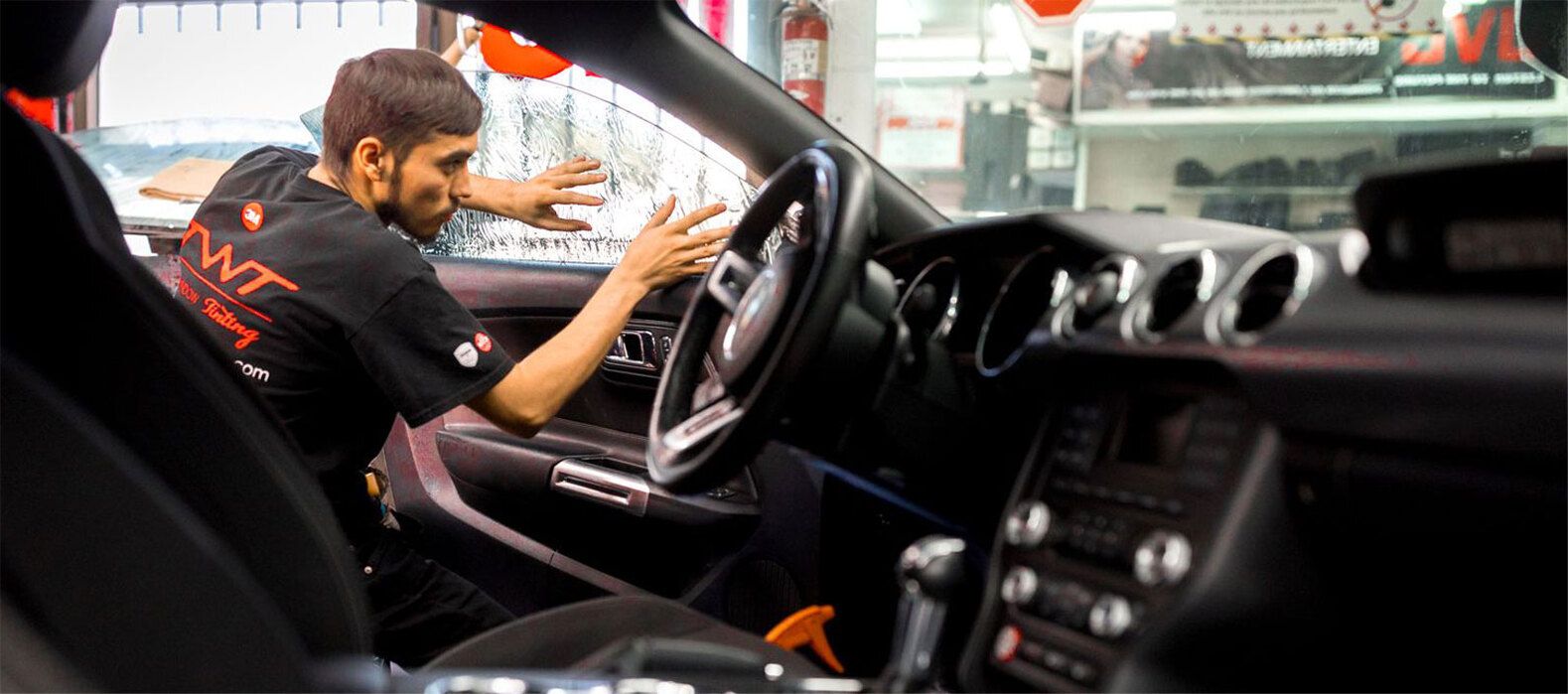 Professional installer applying window tint
